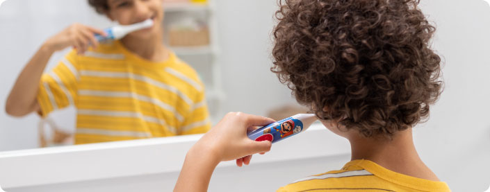 Kid using Super Mario Spinbrush.